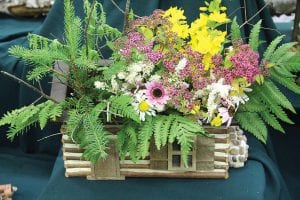 Above: This little log cabin display titled Country Living, created by Carol Evenson, embodies the show’s theme Northland Wonders. Right: This bouquet of delphiniums, Veronica alchemilla, achillea and hosta foliage created by Gan Mesenbring is perfectly titled Aurora Borealis.