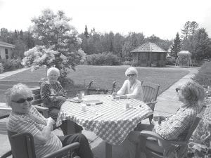 The residents at the Care Center are enjoying this great summer weather for picnics and other outdoor activities. (L-R) Marie Jacobson, Skip Rouser, Phyllis Noyes, and Jane Burley.