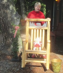 Judy Edlund admires this rocking chair which will be in the Mid-Trail Property Owner’s Auction on August 12 at the Gunflint Fire Station No. 1.