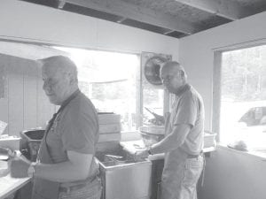 George Haralson and Arvid Dahl cooking fish nuggets at the Elders booth at Rendezvous Days.