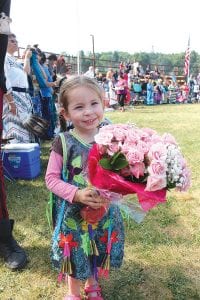 Left: Tiny Tot Princess Zhoomingwenid LeGarde with a beautiful bouquet and a beautiful smile. Middle: Alexis Denny, in vibrant colors, concentrates on her dancing. Right: A dignified Samantha Scalise dances to host drum Stone Bridge Singers.