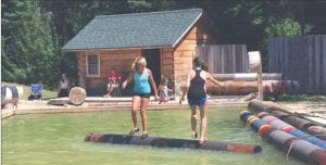 Paige Everson (on the left) studies her opponent’s feet to see if she can make a quick move, which will cause a fall. A winner in a log rolling match is determined when someone takes 3 out of 5 falls.