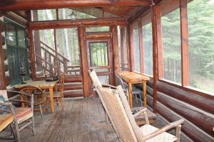 Above: The screen porch just off the dining room is the perfect place to enjoy a morning cup of coffee.