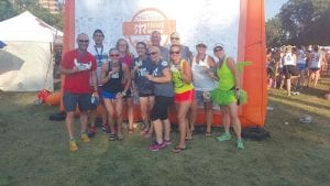 Happy but tired, this group ran a 200-plus mile relay from Winona to Minneapolis two weeks ago as part of the Ragnar Relay. (L-R, front) Lauren Rogahn, Tracey Peterson, Melissa Morell, Lori Yecoshenko, Kathy Bernier (No. 214) and Tina Juckich. (L-R, back) Brian Marx, Nick Schultek, Megan Conde, Keith Graupmann, and Becky Grams. (Not pictured: Sylvia Garcia.)