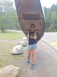 Clare Jencks (hoisting a canoe) and Ann Raiho loaded down with front packs and back packs (and her gift from an Inuit village, her dog, Myhan) recently completed a 212-mile paddle/portage from Crane Lake to Grand Portage in 100 hours. The two adventurers believe they set a record for the route, and challenge others to break it.