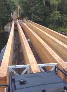 The replacement of the “pink bridge,” the U.S. Forest Service bridge on the 600 Road that crosses the Temperance River near the Sawbill Trail in Tofte is well under way. Top: New beams have been laid and at press time Edwin E. Thoreson, Inc. is laying the decking. Above left: The old bridge, originally built in 1913, practically crumbled as it was being taken out. Above Right: Edwin E. Thoreson, Inc. crane operators deftly removed the old and installed the new bridge pieces.