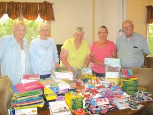 Some of the Cook County Senior Center folks with the wonderful variety of supplies donated by community members for students at ISD 166. (L-R) Betty Larsen, Gladys Anderson, Linda Johnson, Program and Services Coordinator Jes Rodne, and Fred Schmidt.