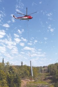 The towers for the new Lutsen Mountains gondola were airlifted by a Sikorsky S-61 helicopter operated by CHI Aviation of Howell, Michigan on Monday, September 14. Ground and tower-climbing crews from the ski lift company Doppelmayr quickly set this 8,000-pound tower in place. See more of the exciting installation process on page A3.