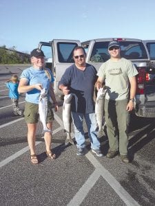 Family and friends of Kevin and Sue Johnson of Schroeder had a great weekend of fishing. (L-R) Anna Carman of Lutsen with a 5.5-pound Coho salmon, Cary Weatherhead of Metamora, Michigan with a 9-pound lake trout; and Jesse Johnson of Schroeder with a 7.2-pound lake trout. The group caught several smaller fish as well.