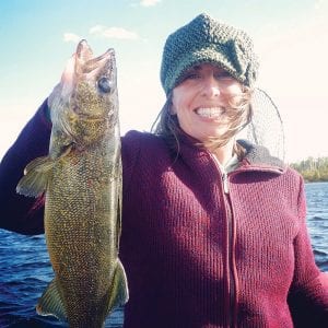 Rachelle Christianson with the beautiful 22-inch walleye caught on September 19 on the Canadian side of Saganaga Lake, fishing with Gunflint Trail fishing guide and Tails from the Trail columnist Cory Christianson.