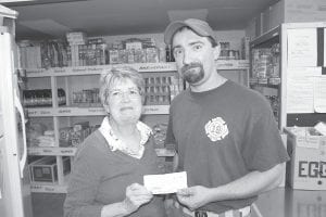 One of the missions of the Sons of the American Legion, Post 413, in Grand Marais, is to serve the community. The Legion Sons have done this for many years by contributing to the Cook County Food Shelf. The Food Shelf has seen a great increase in use in the past year and volunteer Gwen Lenz said there have been shortages. On the September 7 distribution day, the Food Shelf had insufficient supplies of many staples, such as canned vegetables, macaroni and cheese and fruit juice. Lenz said the Food Shelf would put the $800 donation to good use. American Legion Sons member Ben Silence presented the check to the Food Shelf on September 14. To find out how you can help the Food Shelf, call Lenz at (218) 387-9860.