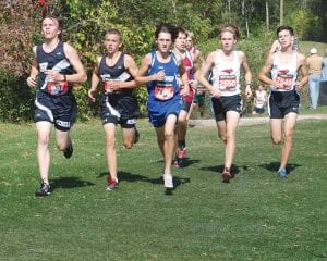 Above: At this point in the race 10th grader Jake Paron (786) had company. At the finish he was alone in first place with a fine time of 16:38. Left: Running strong in the 8th grade girls' race were (LR) Robin Henrikson (805), Malin Anderson (798) and Hazel Oberholtzer (811).