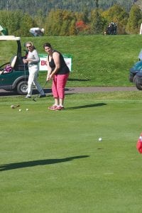 Above: Cook County Community YMCA Director Emily Marshall urged her putt on, but it died on the lip of the cup.