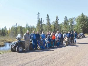 Top: The fall colors were not peaking yet on the Cook County ATV Club’s Fall Ride from downtown Grand Marais to the Mid-Gunflint Trail area on Saturday, September 19, but riders still enjoyed the scenery. Most of the group posed for a photo at this pretty spot on Pine Mountain Road near Mud Creek. Left: ATVers started from Steve’s Sports in Grand Marais, but others joined the group on County Road 7, the Meridian Road (seen here), and Devil Track Road and at the South Brule trailhead. Above: Some of the riders visiting outside Trail Center Lodge. The men joked that between the four of them they had 314 years of riding experience. (L-R) Charlie Tice, John McClure, Richard Bockovich, Gene Erickson.