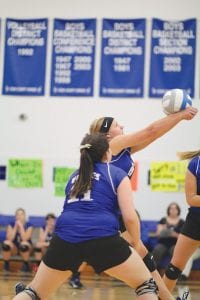 Above: With Trace McQuatters (11) looking on, Tarin Hansen bumped a ball to her front line in the game against Silver Bay. Right: Poised to strike, Meredith Sutton went up high to spike the ball against the Mariners.
