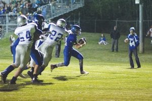 Above: Viking running back Rory Bakke crossed the goal line on this play to make the score 12-12. Bakke finished his night with 12 carries for 81 yards against a tough Silver Bay team. Left: Running hard, Josh Prom gets loose behind Ethan Sporn’s (34) block. Both are talented freshmen who start for the Vikings.