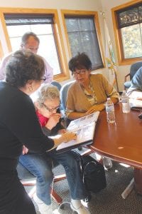 Below: Everyone enjoyed looking through the catalog of items in the collection and sharing memories of the people who have made them.