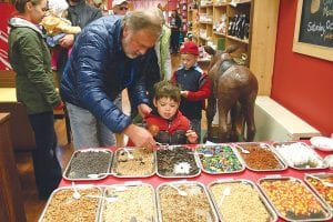 Moose Madness offers lots of sweet activities, like decorating caramel apples at Gunflint Mercantile. Jack and Emmett Stone pick out their tasty embellishments.