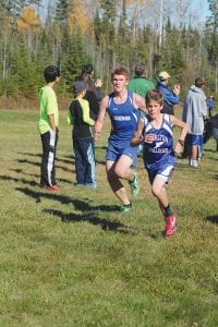 Leif Anderson (left) improved his best time by about one minute at the conference meet. Anderson finished with a fine time of 20:19.