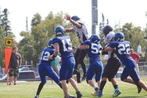 Above: Blocking is everything in football. Here Sam O’Phelan (12), Dylan Works (54), and Frankie Miller (22) did a great job of protecting quarterback Leo Johnson (15) against North Woods defenders. Left: All year Andrew Lashinski has done a great job of punting the ball and kicking extra points for the Vikings. Lashinski even converted a 37-yard field goal. Frankie Miller snaps the ball to Leo Johnson who is holding for the extra point kick, which was good.