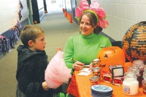 The Birch Grove Community School Halloween Carnival on Saturday, October 25 was wellattended and seemed to be enjoyed by all. This little cotton-candy-eating vampire enjoyed trying to guess how many candy corn were in a jar. See more Halloween Carnival fun inside on page A3.