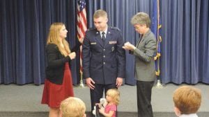 Little Elizabeth and her bunny aren’t sure what’s going on, but October 29 was a big day for her father, Ian Sylvester, who had been promoted to the rank of Captain in the U.S. Air Force. As part of the ceremony, Ian’s wife Colleen (right) and his mother, Annette, pinned his Captain’s bars on his uniform.