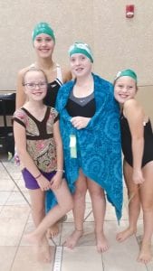 Above: Three Cook County YMCA youth swimmers had their fastest swims ever at a recent meet in Duluth. Pictured here with a swimming fan (left) are (L-R) Ella Hedstrom, Shae Hingos and Liv Hedstrom.