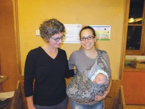 Minnesota Department of Health Research Scientist Patricia McCann visits with Monica Anderson while looking adoringly at baby Edith. Monica and Edith attended the Fish are Important for Superior Health (FISH) update at North House Folk School on November 17 where McCann gave the results of the year long study involving 499 Cook County women.