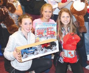 Youths from Bethlehem Lutheran Church in Grand Marais assist with sorting donated toys and clothing items for Operation Family Christmas. A tree with “ornaments” bearing the name of a child and his or her Christmas wish is at the North Shore Federal Credit Union in Grand Marais. Stop by and pick a name, buy a gift and brighten a child’s holiday.