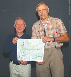 Rick Ridgeway (left), Patagonia vice president of environmental initiatives and special media projects at 3M Company and Martin Kubik of Boundary Waters Advisory Committee (BWAC), present a map of the Powwow Trail at a 3M “Sustainability Talk” on October 29. Patagonia is a longtime supporter of the BWAC.