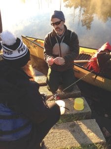 Dave Seaton of Hungry Jack Outfitters showing Amanda Cowette, chef at Wise Acre Eatery in Minneapolis, how to tie on a lure.