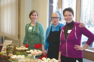 Volunteers Ada Igoe, Mary Igoe, and Gwen Danfelt (left to right) man the table piled high with a delicious assortment of cupcakes, bars, and other desserts for Empty Bowls. See more on page B3.