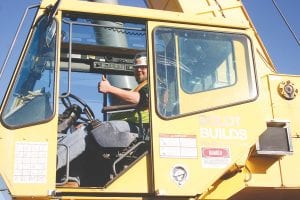 Corey Nelson gives big thumbs up from the seat of the 75-foot crane that he operates at the Cook County North Shore Hospital/Care Center. Nelson, from Chisholm, is the grandson of Sharon Bloomquist and is staying with her while he works on the job for Boldt Construction.