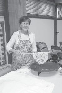 Above left: Phyllis Parker with a lefse, hot off the griddle. Above: Kris Hedstrom (with Annie DeBevec in the background) rolls out the lefse dough.