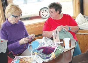 Nancy Kemp and Fran Koscielak, knitting and chatting at the Fiber Guild Tuesday get-together at Java Moose in Grand Marais.