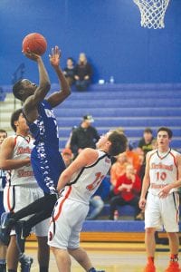 Far left: Sam O’Phelan rose up high to score two of his 15 points against the Nashwauk-Keewatin Spartans in the Vikings’ home opener played last Friday night. Above: Lucas Phillips (21) tips off the basketball season against Spartan guard Kaleb Pelkey. Inset: Jerod Spry starts a drive toward the hoop. Spry finished with 9 points in the game.