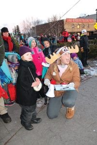 Katie Willard of Visit Cook County cheers as Hailey Anderson of Grand Marais lights the big Christmas tree in Harbor Park.