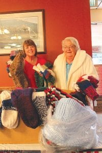 On Veterans Day 2015, the American Legion Post 413 Auxiliary wrapped up its winter clothing drive. One of the last donations was happily accepted by Auxiliary member Nancy Backlund (left). She was happy to help pack up 55 pairs of socks, hand-knit and donated by Donna Wilson of Grand Marais.