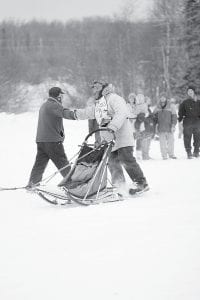 Northland mushers have their fingers crossed for enough snow to fall for the Gunflint Mail Run, scheduled for January 9-10. This 12-dog, 100-mile race is popular with dog sledders and racing fans alike. Pictured here is Shawn McCarty being greeted at the finish line in the 2012 event.
