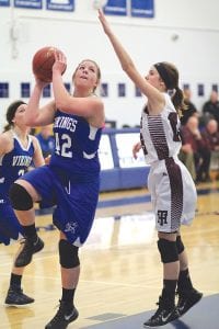 Left: Going up strong for a layup, Emily Jacobsen (42) blew by her defender to score two of her game-high 21 points against Two Harbors. Above: Double trouble! The Toftey twins, Hannah (13) and Sarah (4) don’t score a lot, but both guards play tough defense and work hard to get teammates the ball on offense.