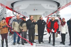 Dignitaries, Lutsen Mountains staff and representatives from Visit Cook County gather for the ribbon cutting. (L-R) Katie Willard of Visit Cook County, Howard Hedstrom with the Cook County Chamber, Grand Marais Mayor Jay Arrowsmith DeCoux, Senator Tom Bakk, Commissioner Mark Phillips from IRRRB, co-president of Lutsen Mountains Charles Skinner, and executive director Linda Kratt from Visit Cook County gather on the gondola platform on Moose Mountain.