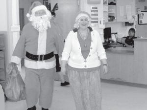 Left: Santa and Mrs. Claus made a surprise visit to the Care Center Christmas party on Dec. 24. Above: Hilja Iverson making lefse for the residents and staff to enjoy.