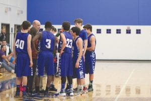 Above: Head Coach Mitch Dorr gives his team instructions during a time-out. Although the Vikings aren’t very big, they rebound well and play tough defense as demanded by their head coach. Left: No one was stopping senior guard Jarod Spry (No. 24) on this play as he slashed to the basket for two points.