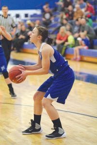 Above: Something not often seen, Maya McHugh takes aim at the basket. McHugh is noted more for her defense and passing than scoring. Right: Sophie Eliasen (No. 31) is just a ninth-grader, but she is in her second year as a starter for the varsity. Eliasen has been scoring in double digits for the Vikings this year, and has improved her 3-point shooting by practicing over the summer. Sophie launched a long shot that hit nothing but net in a recent home game against Two Harbors.