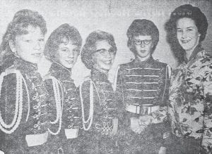 Bev Olsen, right, president of the local high school band, congratulates the four new members who were inducted in December 1962. They are, from left, Susan Hall, Debbie Krueger, Cheri Toftey and Lynn Benson.