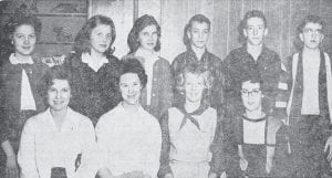 Eleven Cook County High School students were inducted into the local chapter of the National Honor Society at a candlelight ceremony in the school auditorium on Dec. 12, 1962. The guest speaker was Justine Kerfoot of Gunflint Lodge, who spoke on the characteristics of an educated person. Shown from left, front row, are Sharon Muehlberg, Beverly Olsen, Maureen Olsen and Carole Thompson. In back row are Carol Maxfield, Iris Mueller, Diane Anderson, Orton Tofte Jr., Stanley Smith and Jim White. Jim Rasmussen was absent, ill with the mumps, when the photo was taken.