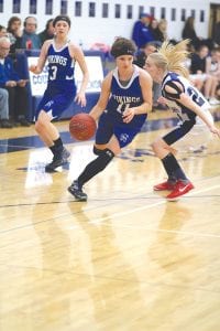 Eighth-grader Abbie Crawford shows off her ball handling skills as she beat her defender to the basket.