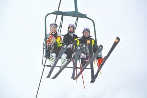 As snow alternated between heavy and wet to light and fluffy on Thursday, January 14, the Cook County Alpine Vikings showed off their Slalom skills on Moose Mountain. Santina McMillan, Alyssa Martinson and Madysen McKeever are all smiles on the 10th Mountain chairlift at Lutsen Mountains.