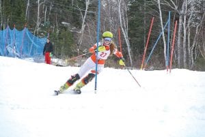 Above: Eighth-grader Halle Lamb maneuvers to block a gate. Left: Consistent, fast-skiing eighth-grader Masen McKeever crushes a SL gate.