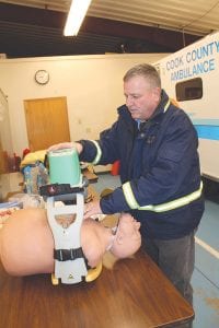 Cook County North Shore Hospital Ambulance Director Steve DuChien demonstrates how the LUCAS automated chest compression device works. The device, which the hospital received because of a grant from the Leona M. and Harry B. Helmsley Charitable Trust, allows emergency workers to give uninterrupted CPR while attending to a patient’s other needs. DuChien said the machine could be a lifesaver.